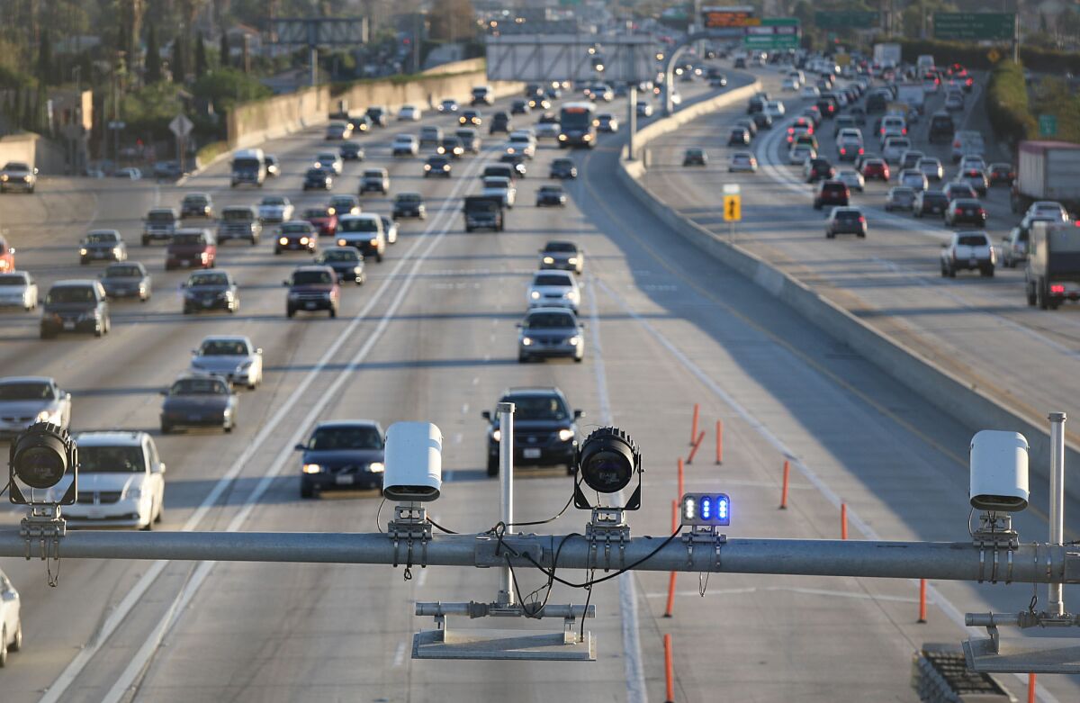Cameras and electronic sensors stand over the toll lanes south of the Slauson Ave. transit station on the 110 Freeway.