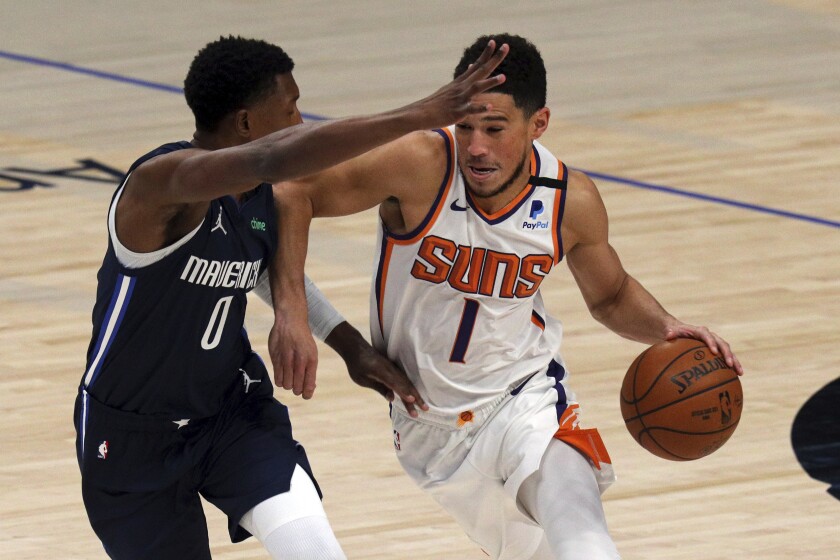 Dallas Mavericks guard Josh Richardson defends against Phoenix Suns guard Devin Booker.