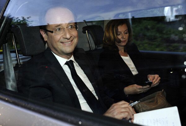 François Hollande arrives with his companion Valerie Trierweiler to give a speech in Tulle, France, after winning the second round of voting in the presidential election.
