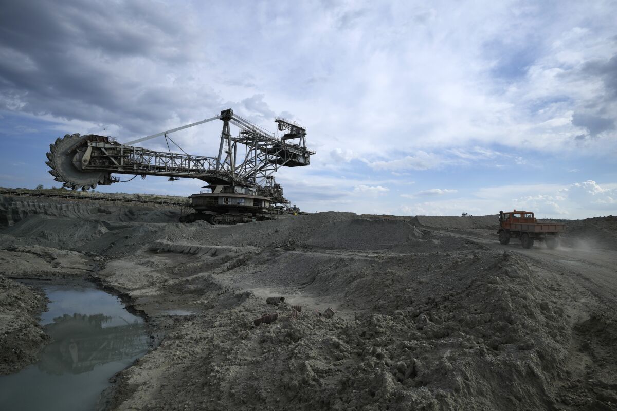 A coal excavator sits at Greece's largest mine outside the northern city of Kozani on Thursday, June 2, 2022. Energy market turmoil caused by the war in Ukraine has triggered an increase in coal-fired electricity production in the European Union and a temporary slowdown in the closure of power plants long-earmarked for retirement. (AP Photo/Thanassis Stavrakis)