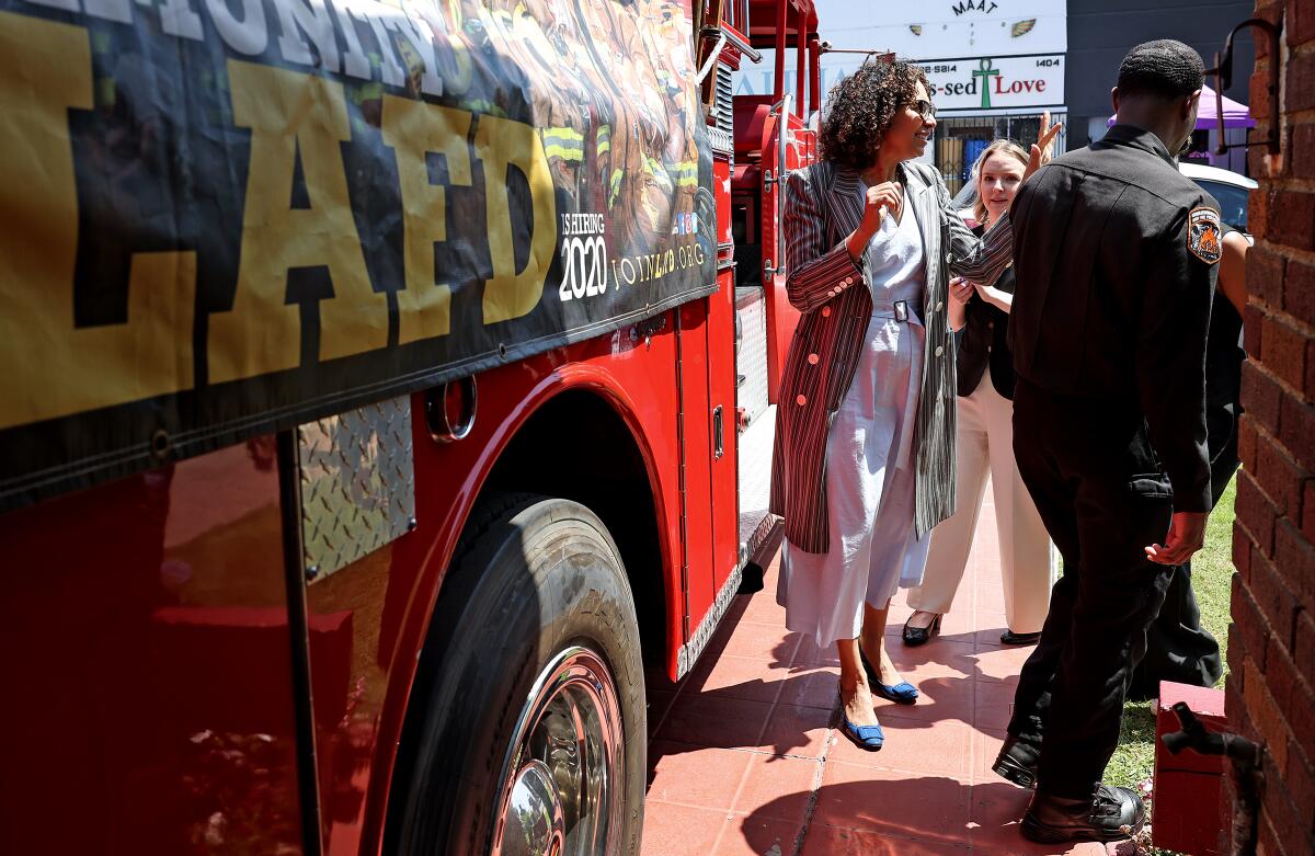 Rep. Sydney Kamlager-Dove stands near a fire truck.