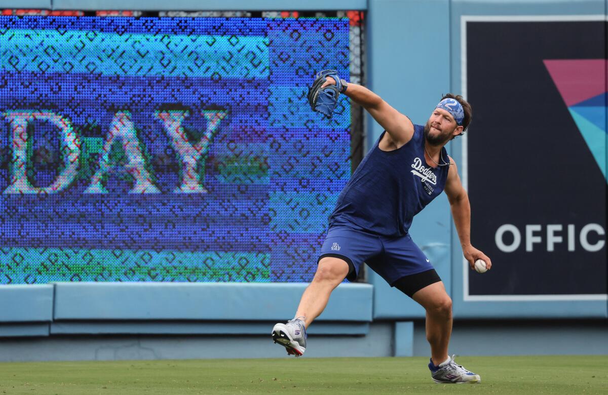 Dodgers pitcher Clayton Kershaw throws long toss while rehabbing from surgery before a game at Dodger Stadium. 