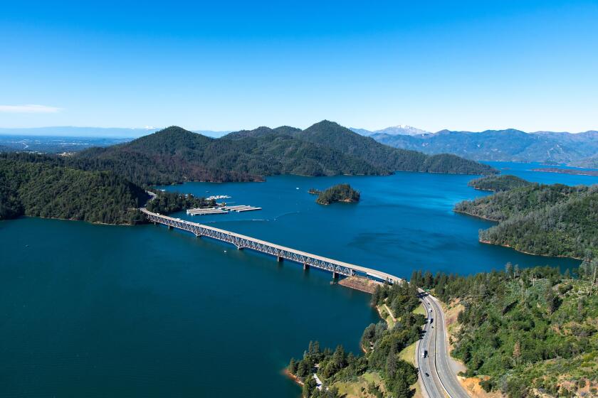 An aerial view of Pit River Bridge that spans Lake Shasta and the adjacent marina in Shasta County, California.