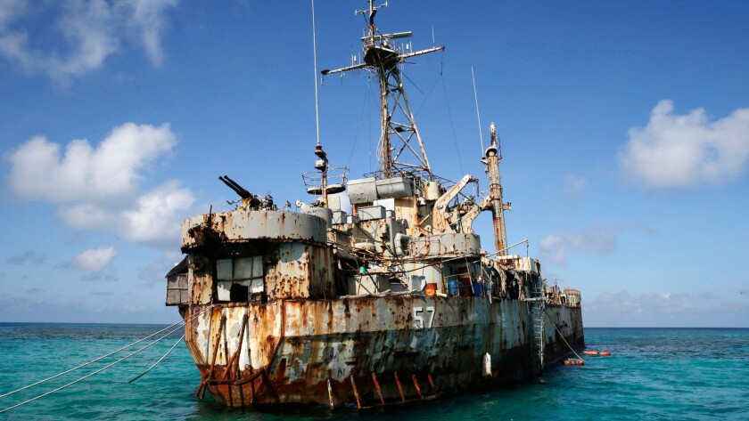 A Philippine Navy ship floats in a shallow region of the South China Sea in 2014. When diplomacy went nowhere and Chinese vessels seized a disputed shoal and then surrounded another reef, Filipino officials took a desperate step: They went to court.