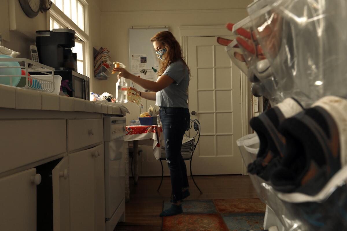 At Ladybug Childcare & Preschool in San Francisco, teacher Edith Amaya sanitizes toys.