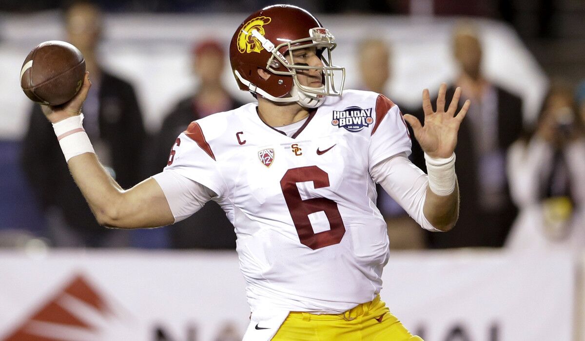 USC quarterback Cody Kessler throws a pass during the first half of the Holiday Bowl against Wisconsin on Wednesday.