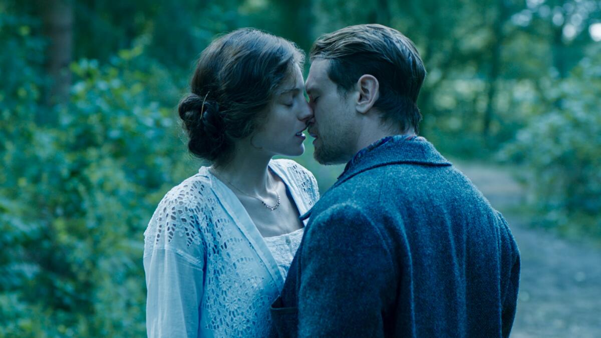 A man and woman lean in close for a kiss in a scene from "Lady Chatterley's Lover."