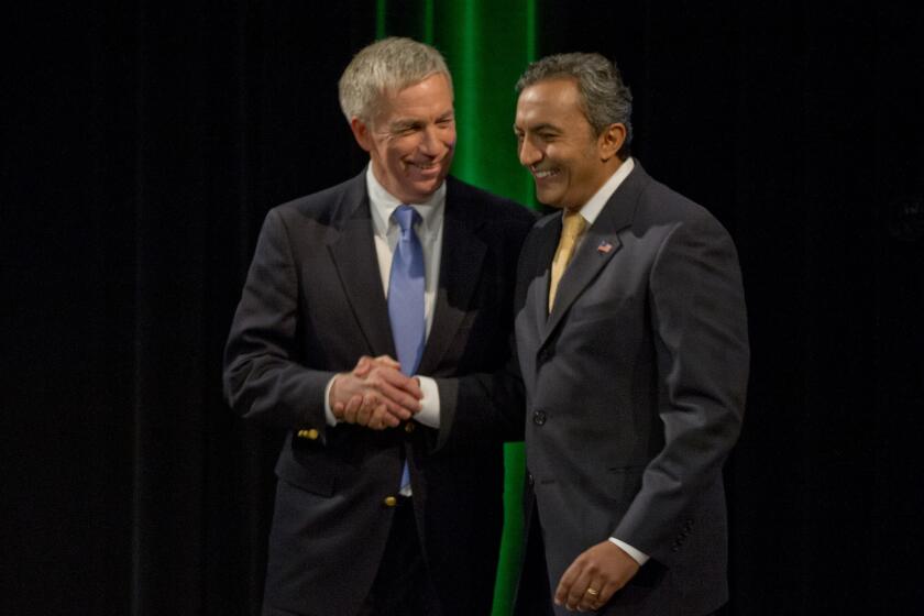 Incumbent, Democratic Rep. Ami Bera, right, and Republican Doug Ose, left, shake hands after debating for the 7th Congressional District in Sacramento last month.