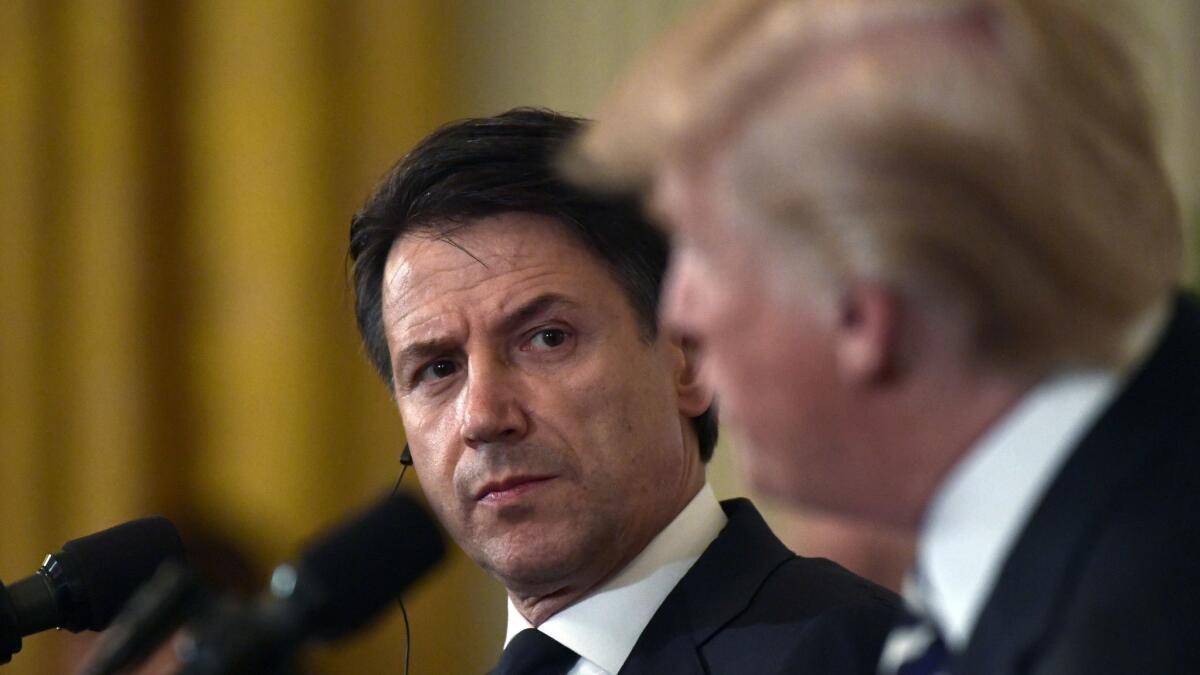 Italian Prime Minister Giuseppe Conte listens as President Trump takes a reporter's question at the White House on Monday.