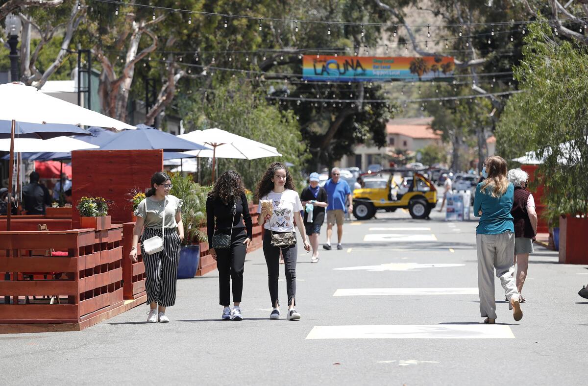 People stroll the new Promenade on Forest in downtown Laguna Beach, which opened last week.