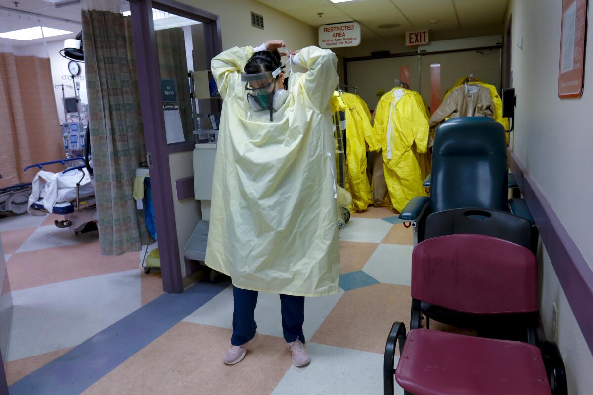 Lizabeth Velasquez puts on PPE in the COVID section of El Centro Regional Medical Center