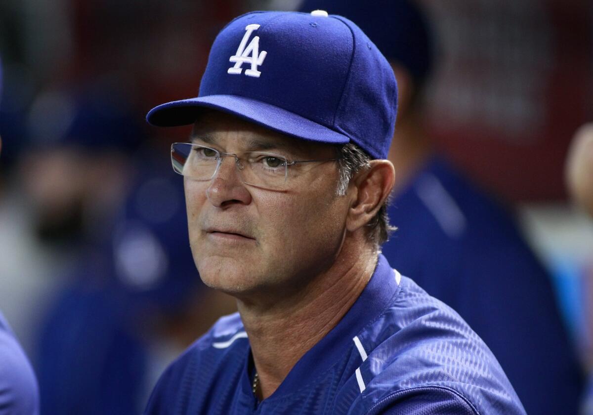 Don Mattingly looks on from the Dodgers dugout on Sept. 12.