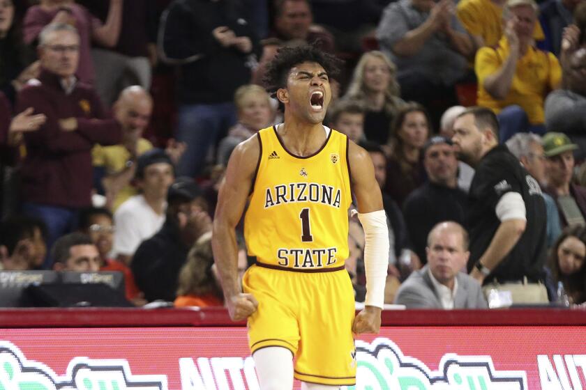 FILE - In this Feb. 22, 2020, file photo, Arizona State's Remy Martin (1) shows his feelings after a run by his Sun Devils against Oregon State during the second half of an NCAA college basketball game in Tempe, Ariz. Martin was selected to the Associated Press All Pac-12 team selected Tuesday, March 10, 2020. (AP Photo/Darryl Webb, File)