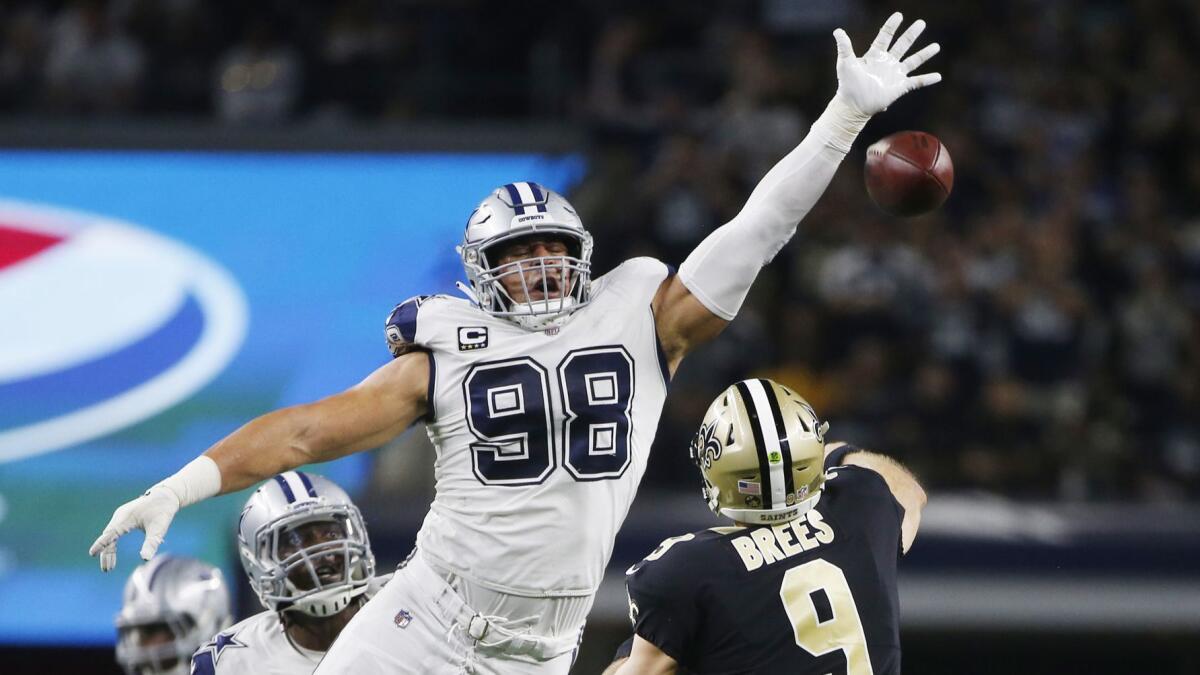 New Orleans Saints quarterback Drew Brees (9) is pressured by Dallas Cowboys defensive tackle Tyrone Crawford (98).