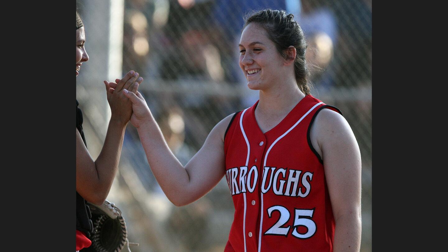 Burroughs' Presley Miraglia is congratulated after a strong inning of pitching against Burbank in a rival Pacific League softball game at McCambridge Park in Burbank on Thursday, May 11, 2017.