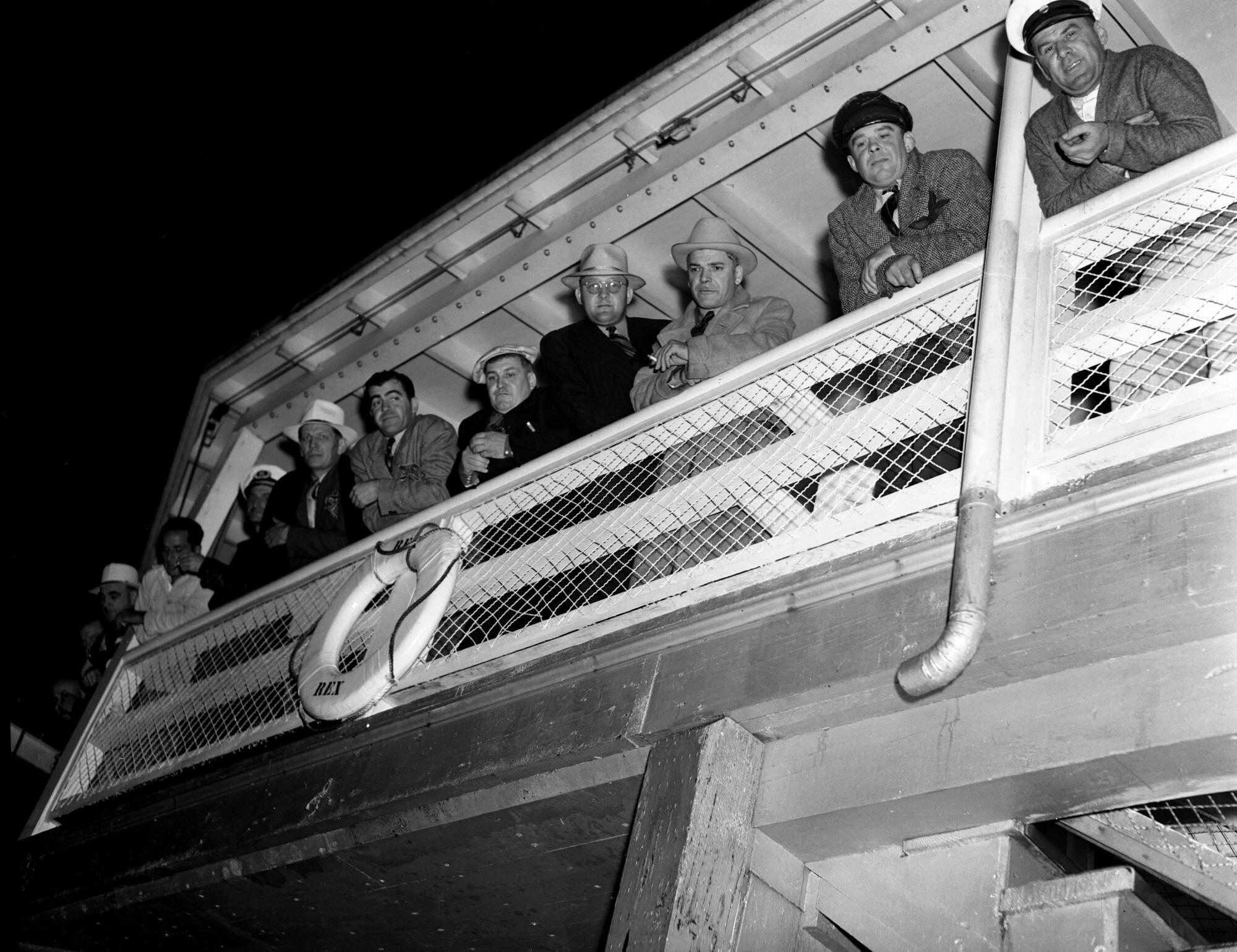 Tony Cornero, third from right, huddles with associates aboard the S.S. Rex amid 1939's Battle of Santa Monica Bay.