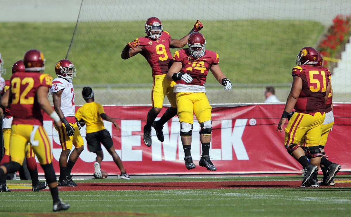 USC receiver JuJu Smith (9) celebrates a touchdown with tackle Nico Falah (74) during the Trojans' spring game on April 11.