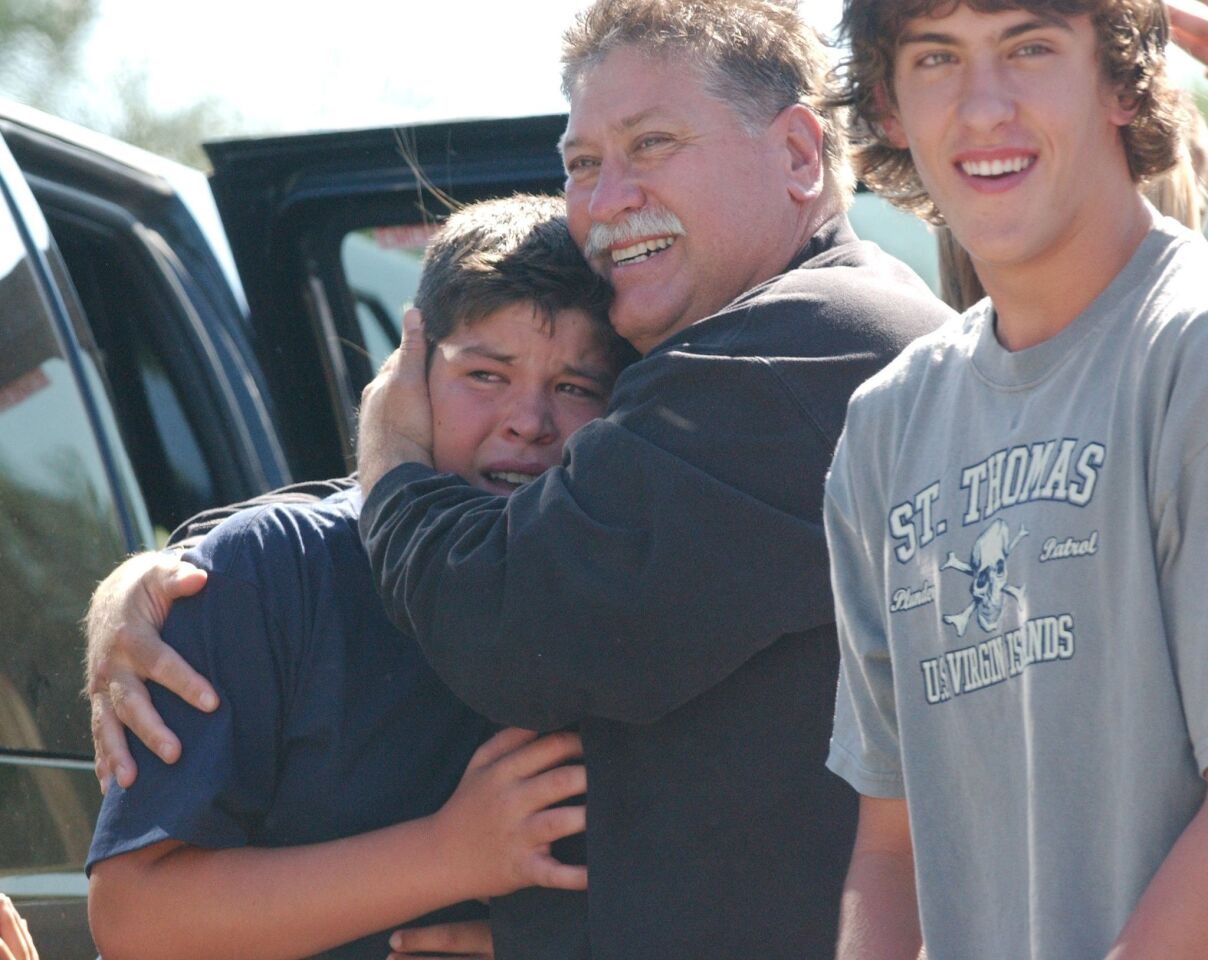 Brian Wofford, rejoices with his sons Aaron, left, and Luke, right, on June 30, 2004, after arriving at their Encinitas home following a surprise weeklong remodel that quadrupled their house in size on the ABC television series "Extreme Makever: Home Edition."