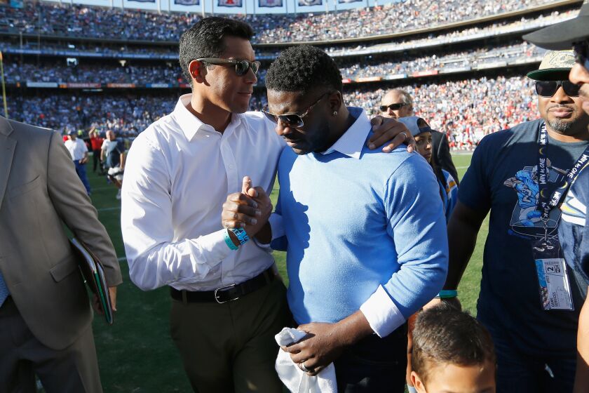 SAN DIEGO, CA - NOVEMBER 22: Former NFL Player LaDanian Tomlinson shakes hands with former NFL Player Donnie Edwards after he had his number retired by the San Diego Chargers during halftime of a game against the Kansas City Chiefs at Qualcomm Stadium on November 22, 2015 in San Diego, California. (Photo by Sean M. Haffey/Getty Images)
