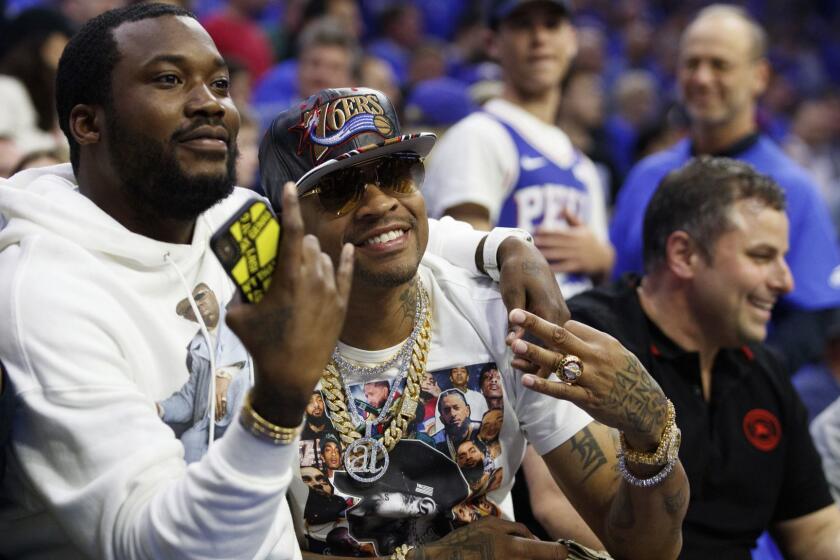 Former 76ers' Allen Iverson, right, poses with rapper Meek Mill, left, during the first half of Game 3 of a second-round NBA basketball playoff series against the Toronto Raptors, Thursday, May 2, 2019, in Philadelphia. 76ers won 116-95. (AP Photo/Chris Szagola)