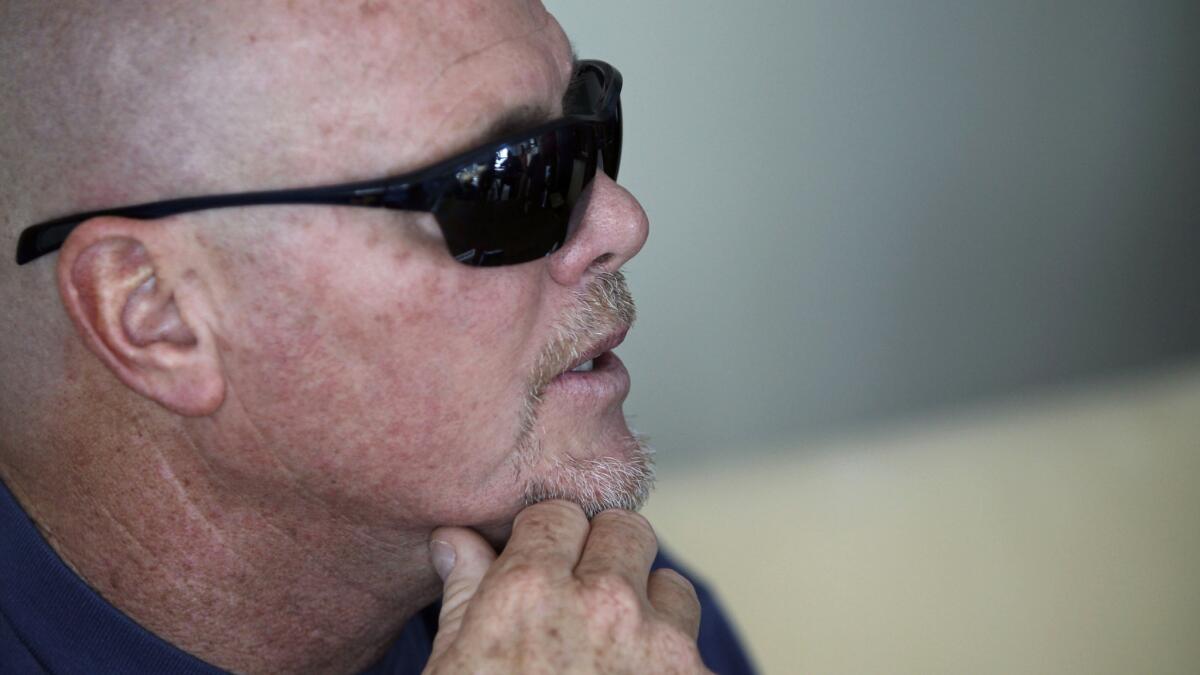Former Chicago Bears quarterback Jim McMahon speaks during a news conference on June 17. McMahon, who has been battling dementia, is among a group of former NFL players who have sued the league over its handling of player concussions.