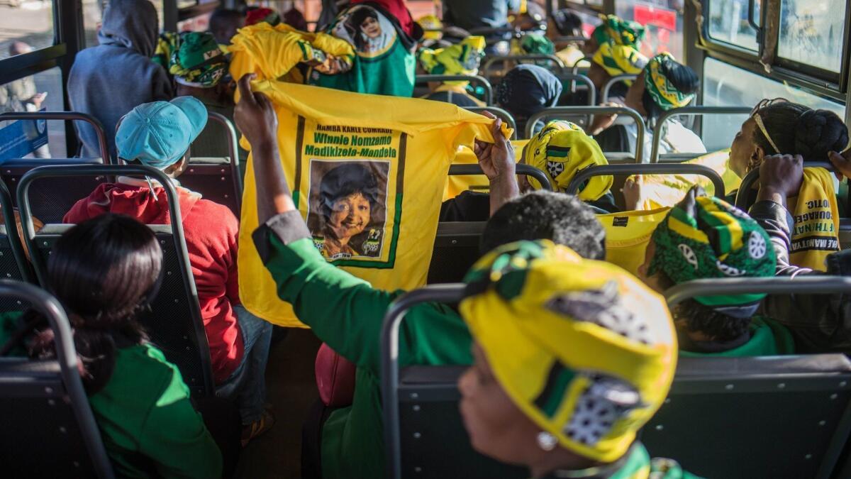 A bus full of mourners travels to Orlando Stadium in Soweto for the funeral of Winnie Madikizela-Mandela Saturday.