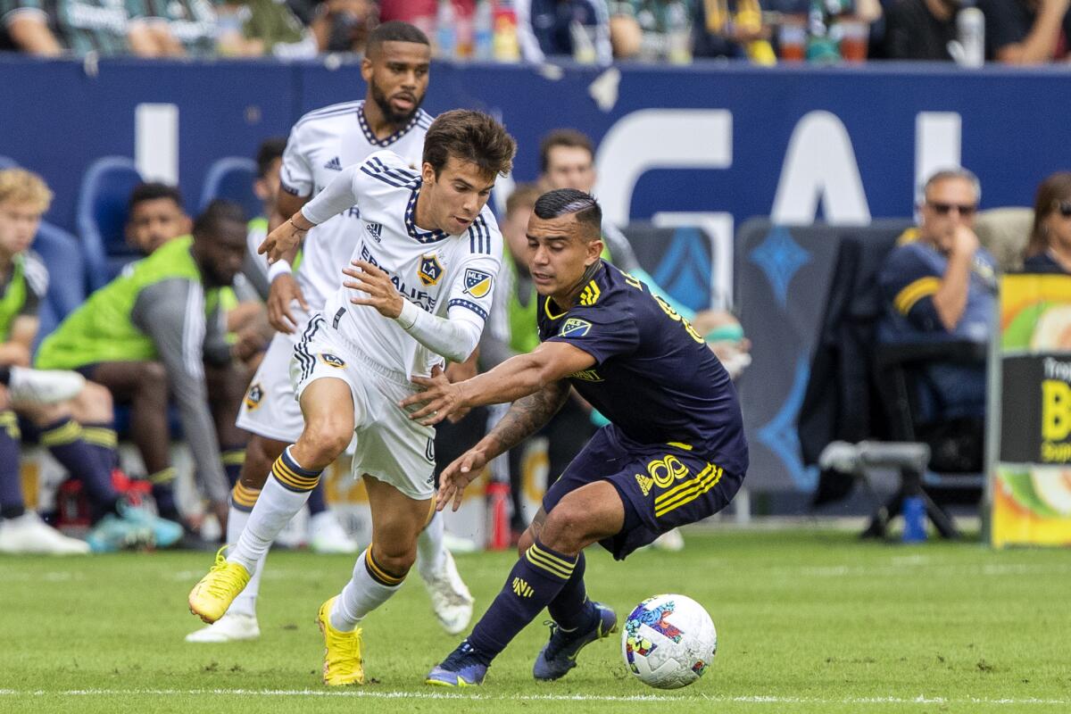 Galaxy midfielder Riqui Puig controls the ball against Nashville SC midfielder Randall Leal.