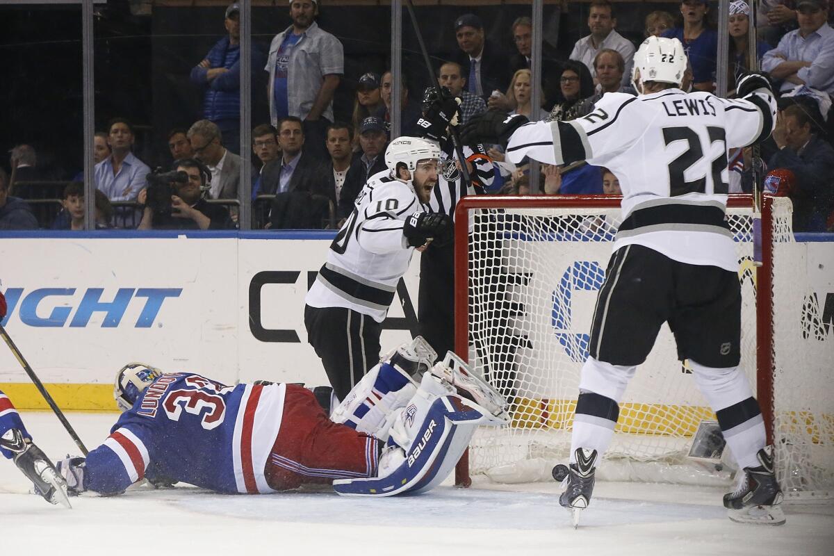 Kings forward Mike Richards, left, celebrates with teammate Trevor Lewis, right, after scoring on New York Rangers goalie Henrik Lundqvist during the second period of the Kings' 3-0 win in Game 3 of the Stanley Cup Final.