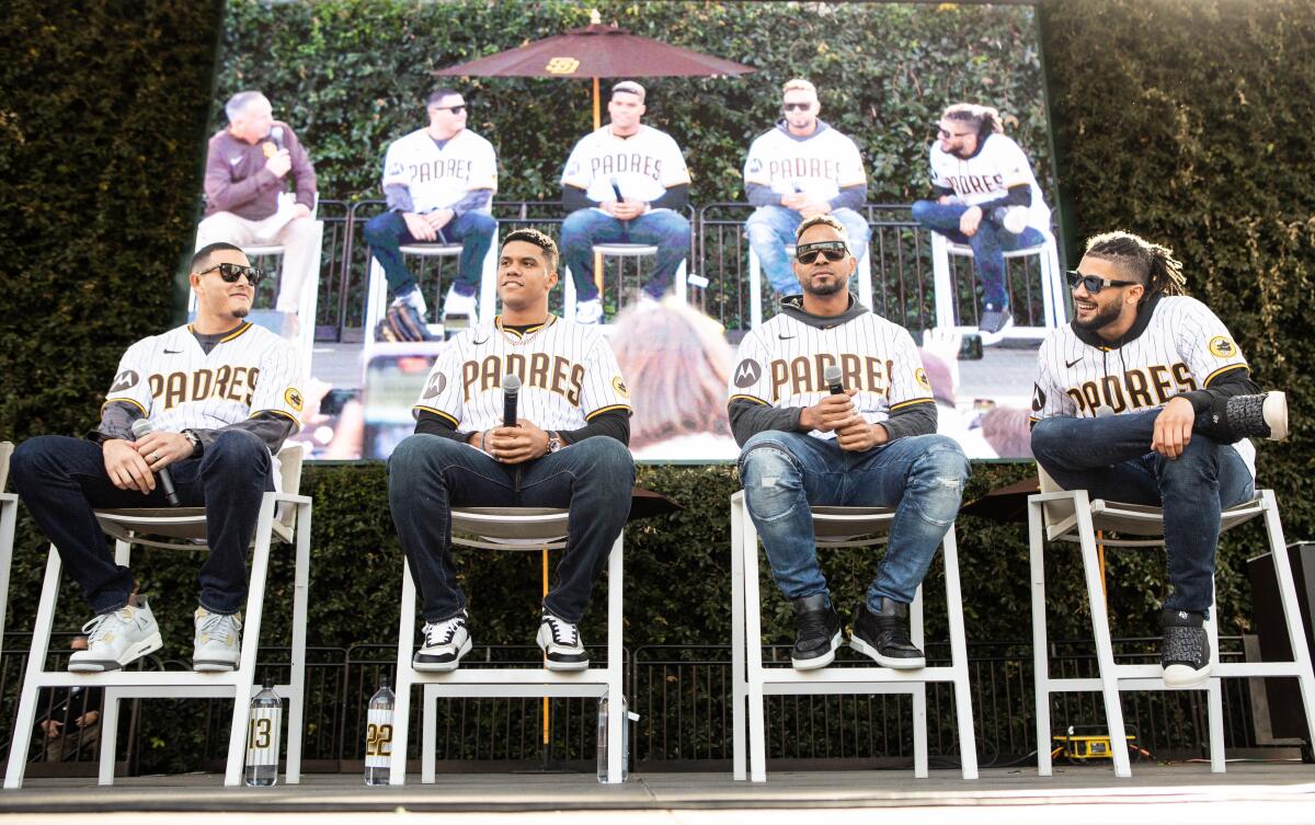 Manny Machado, Juan Soto, Xander Bogaerts, and Fernando Tatis Jr. sit on stage during the Padres' 2023 FanFest 