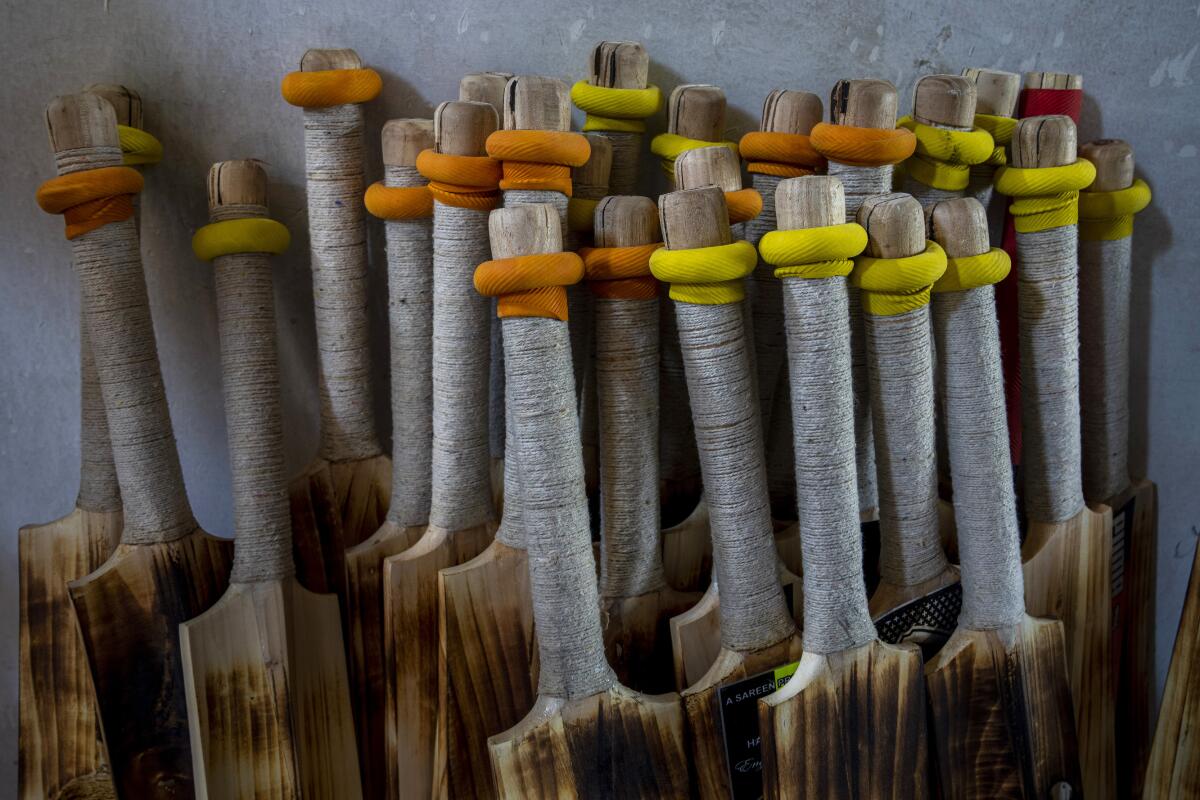 Finished cricket bats are seen inside a factory in Sangam, south of Srinagar, Indian controlled Kashmir, Sept. 22, 2022. Kashmir’s dwindling willow plantations are impacting the region’s famed cricket bat industry and risking the supply of cricket bats in India, where the sport is hugely followed. The industry employs more than 10,000 people and manufactures nearly a million bats a year. (AP Photo/Dar Yasin)