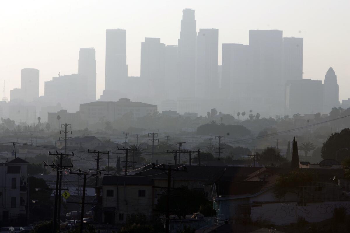 Smog could get worse by mid-century as climate change boosts summer temperatures and accelerates the formation of ozone, a new study says. Above, a hazy day in Los Angeles.