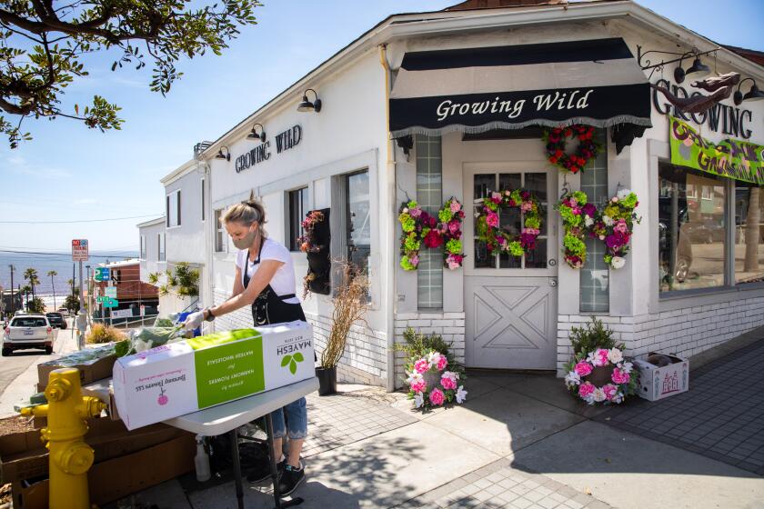 MANHATTAN BEACH, CA - MAY 07: Debra Consani, with the flower shop Growing Wild, in Manhattan Beach, CA, prepares for the upcoming Mother's Day holiday and fulfilling their usual online orders, with additional space outside their store, Thursday, May 7, 2020, during the coronavirus pandemic. The South Bay business has been owned by Lisa Gallien and her sister Lee Bakos for 29 years and Gallien says peonies and lilac are most popular during this time of year and people often add them to their custom bouquets. (Jay L. Clendenin / Los Angeles Times)