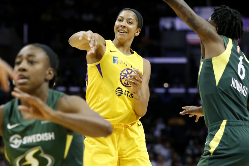 Sparks star Candace Parker passes to a teammate during Sunday's win over the Seattle Storm.