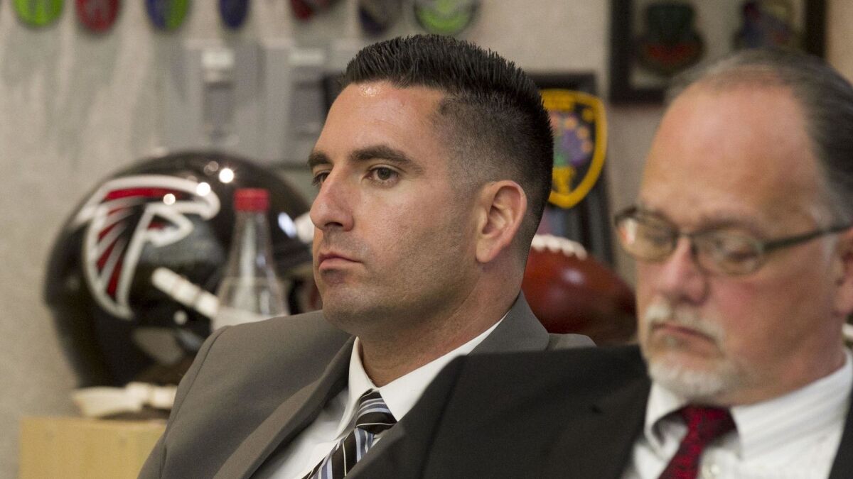 In this file photo from May of 2018, San Diego County sheriff's deputy Richard Fischer, left, is shown at his preliminary hearing in Vista. One of his attorneys, Chris Kowalski, is on the right.