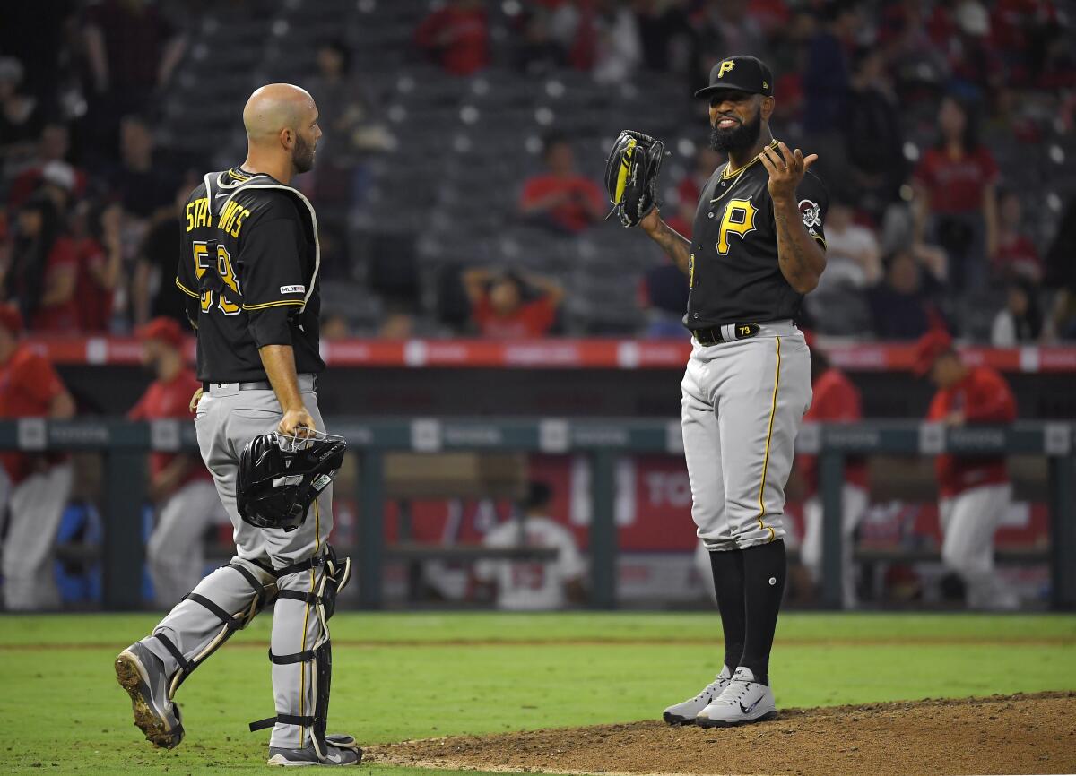 Pittsburgh Pirates closer pitcher Felipe Vazquez, right, gestures to catcher Jacob Stallings after defeating the Angels on Monday.