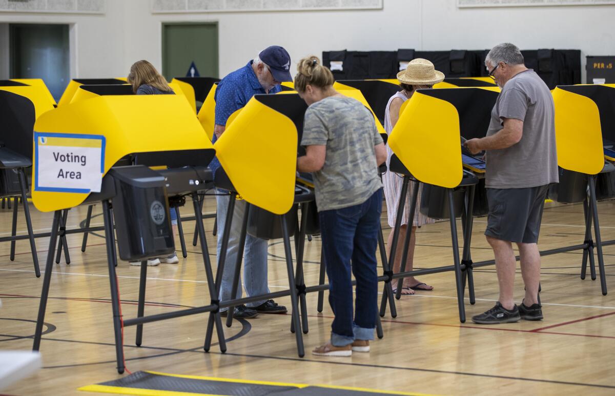 Voters cast their ballots in an election center