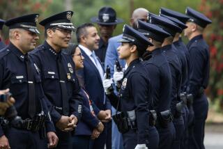 LOS ANGELES, CA - MAY 03: LAPD Capt. Christopher M. Zine, left, and interim Police Chief Dominic Choi meet with recruit class 11-23 during the graduation ceremony at the Los Angeles Police Academy in Los Angeles, CA on Friday, May 3, 2024. (Myung J. Chun / Los Angeles Times)