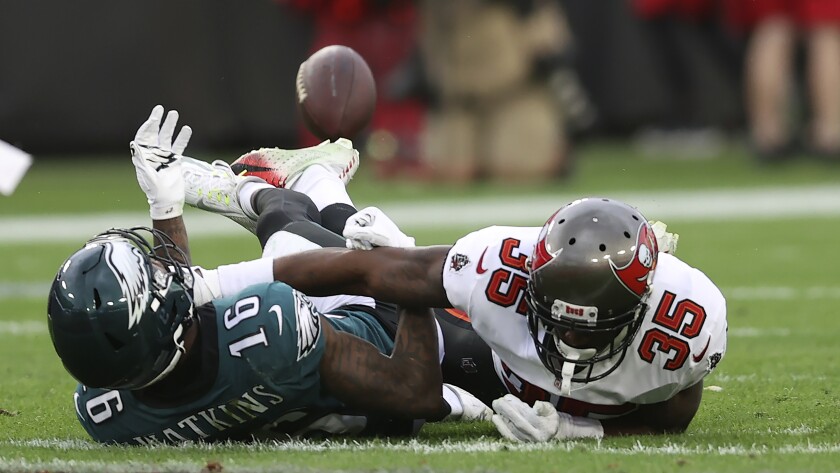 Tampa Bay Buccaneers cornerback Jamel Dean (35) breaks up a pass intended for Philadelphia Eagles wide receiver Quez Watkins (16) during the second half of an NFL wild-card football game Sunday, Jan. 16, 2022, in Tampa, Fla. (AP Photo/Mark LoMoglio)