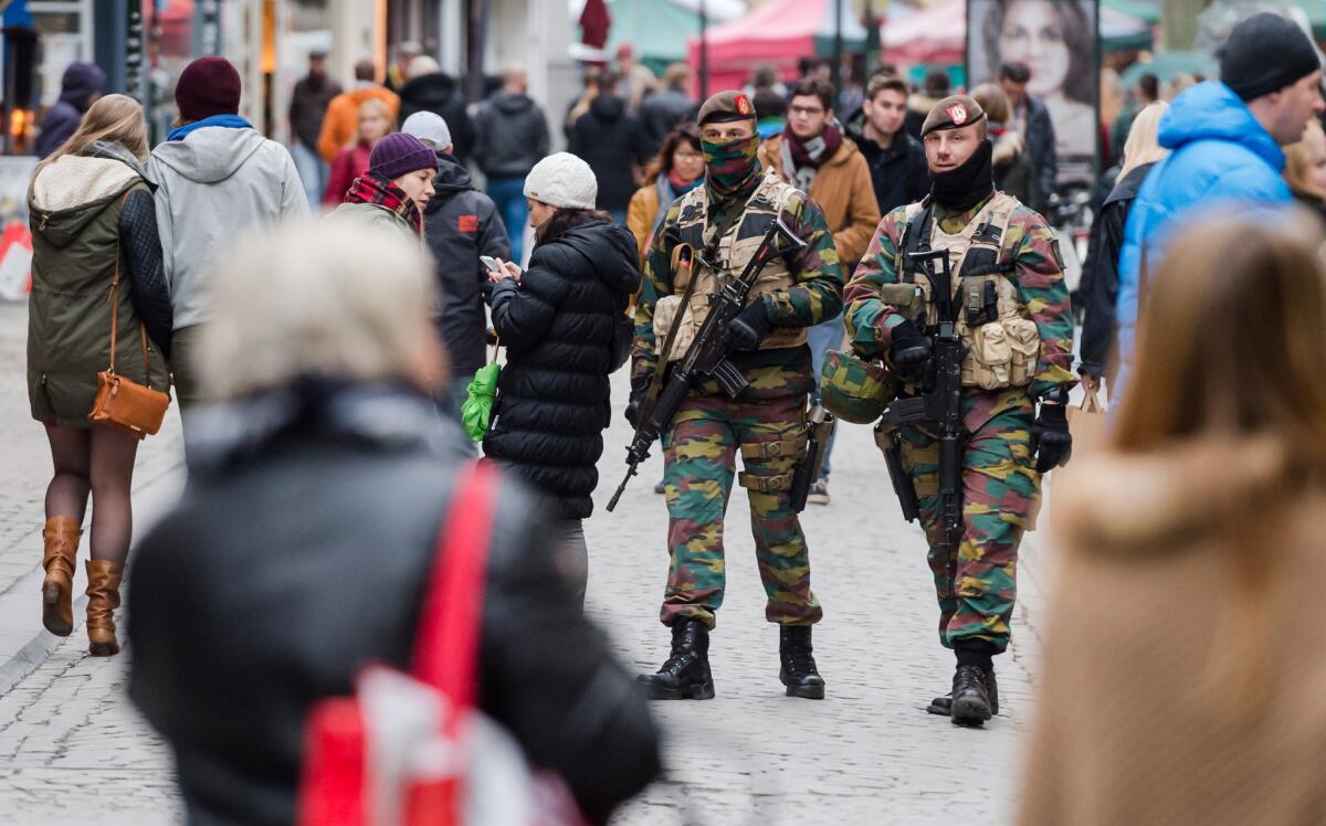 Belgian soldiers patrol in the picturesque Grand Place in Brussels.