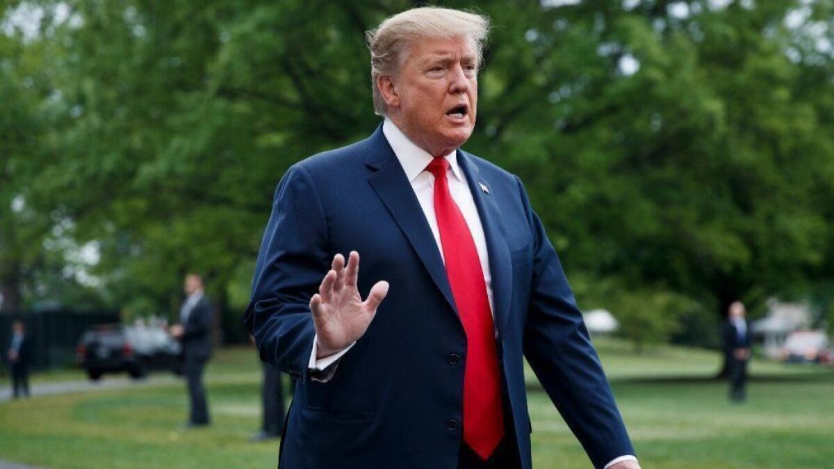 President Trump responds to a question from reporters before boarding Marine One on the South Lawn of the White House on April 26.