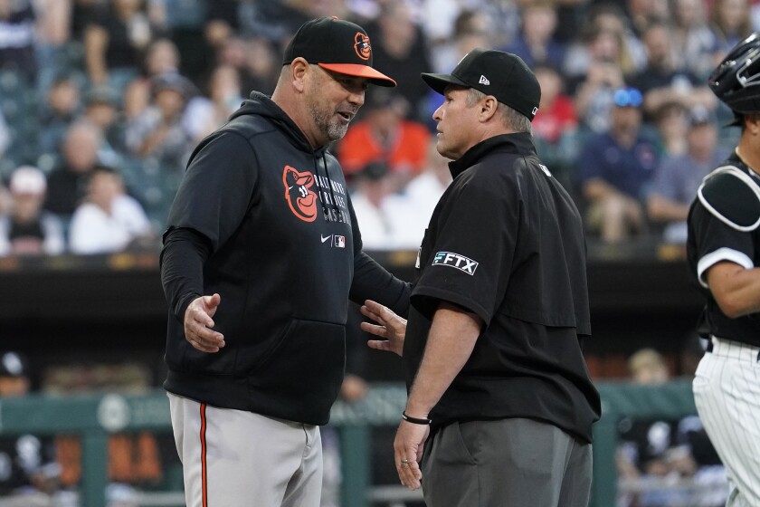 Baltimore Orioles manager Brandon Hyde, left, talks with umpire Marvin Hudson after the benches cleared when an Orioles batter was hit by a pitch during the second inning of the team's baseball game against the Chicago White Sox in Chicago, Friday, June 24, 2022. (AP Photo/Nam Y. Huh)