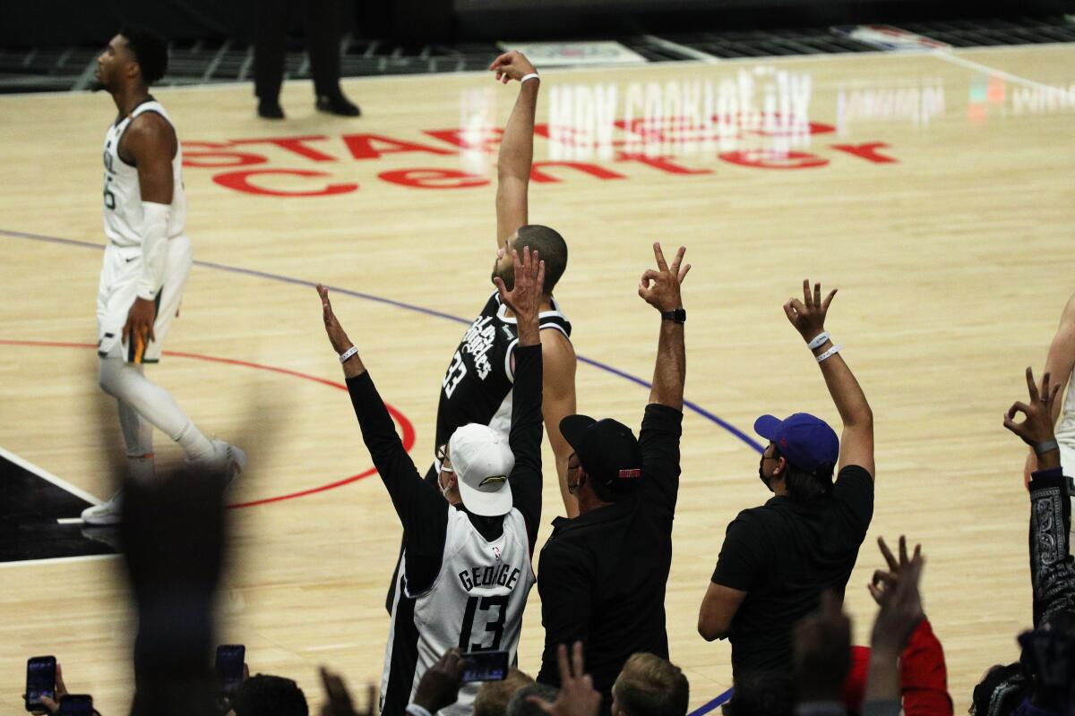 Fans react to a three-pointer by Clippers forward Nicolas Batum.