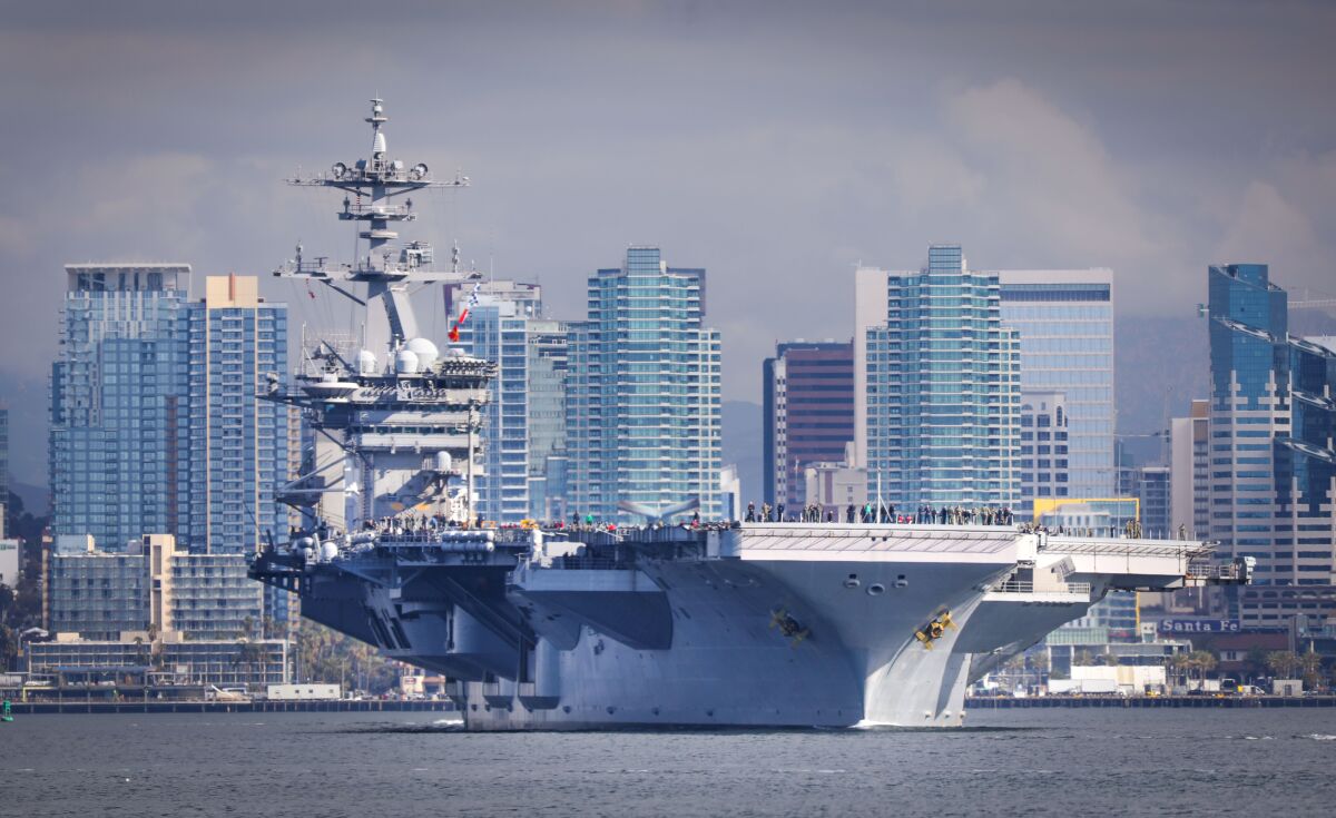 The aircraft carrier USS Theodore Roosevelt, flagship of Carrier Strike Group 9, travels through San Diego Bay after leaving Naval Air Station North Island on January 17, 2020.