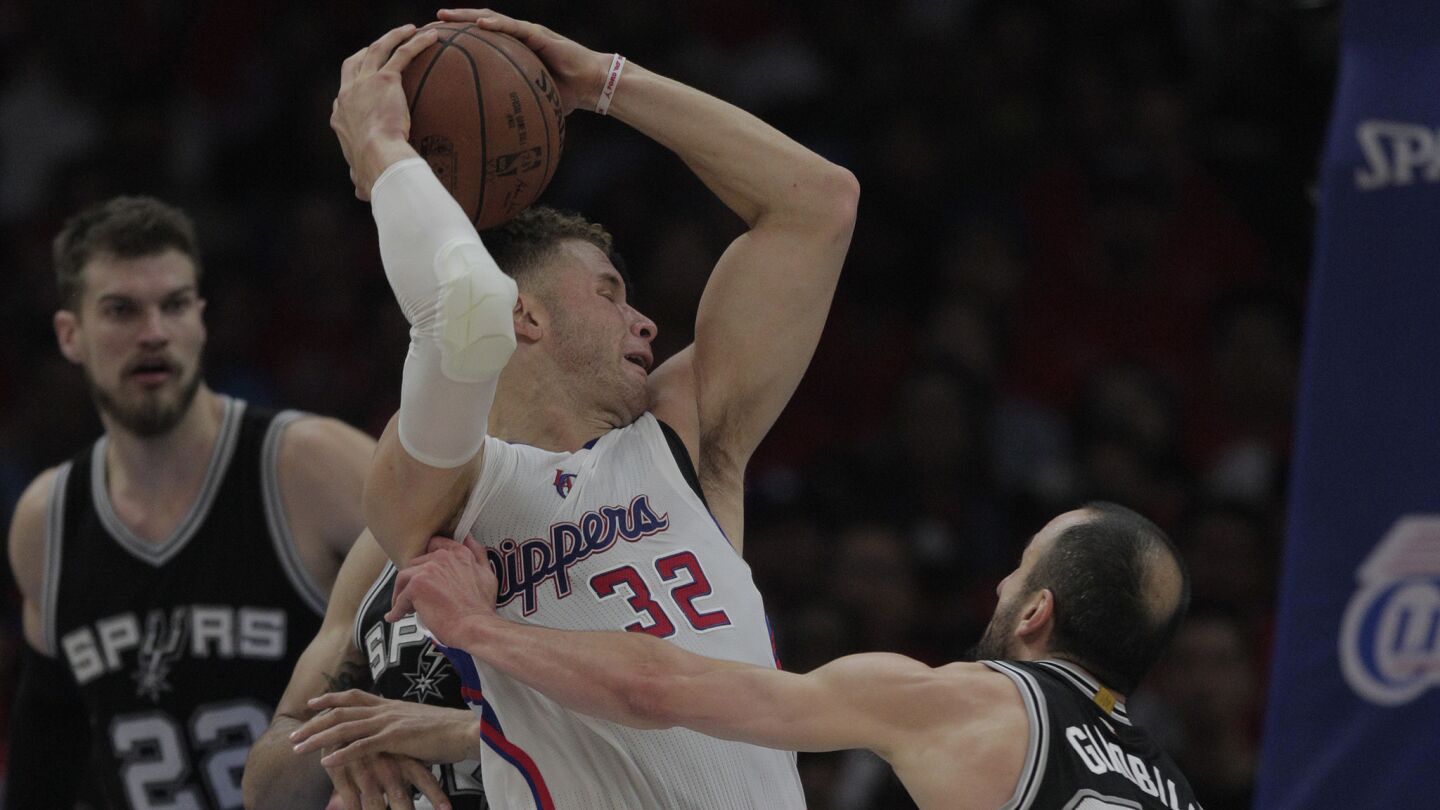 Clippers forward Blake Griffin, center tries to drive past San Antonio Spurs guard Manu Ginobili, right, during the first half of Game 7 of the Western Conference quarterfinals at Staples Center on May 2, 2015.