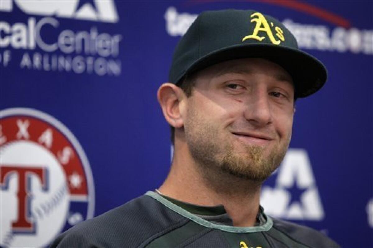 Former Oakland Athletics pitcher Dallas Braden wears a jersey of