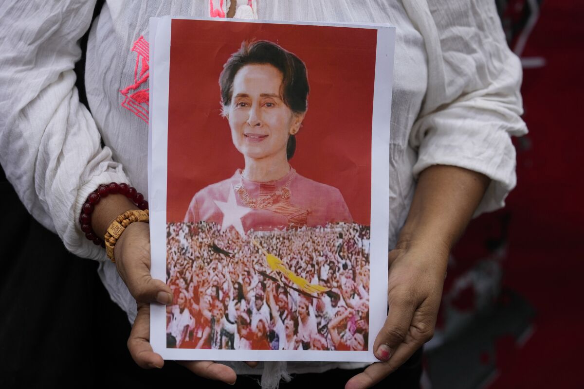 FILE - A supporter shows a portrait of former leader Aung San Suu Kyi during a protest marking the two-year anniversary of the military takeover that ousted her government outside the Myanmar Embassy in Bangkok, Thailand, on Feb. 1, 2023. Lawyers for Myanmar’s ousted leader Aung San Suu Kyi, who is serving a 33-year prison sentence on charges widely considered contrived by the military who overthrew her elected government, have been denied meetings with her even though they are in the process of making several appeals. (AP Photo/Sakchai Lalit)