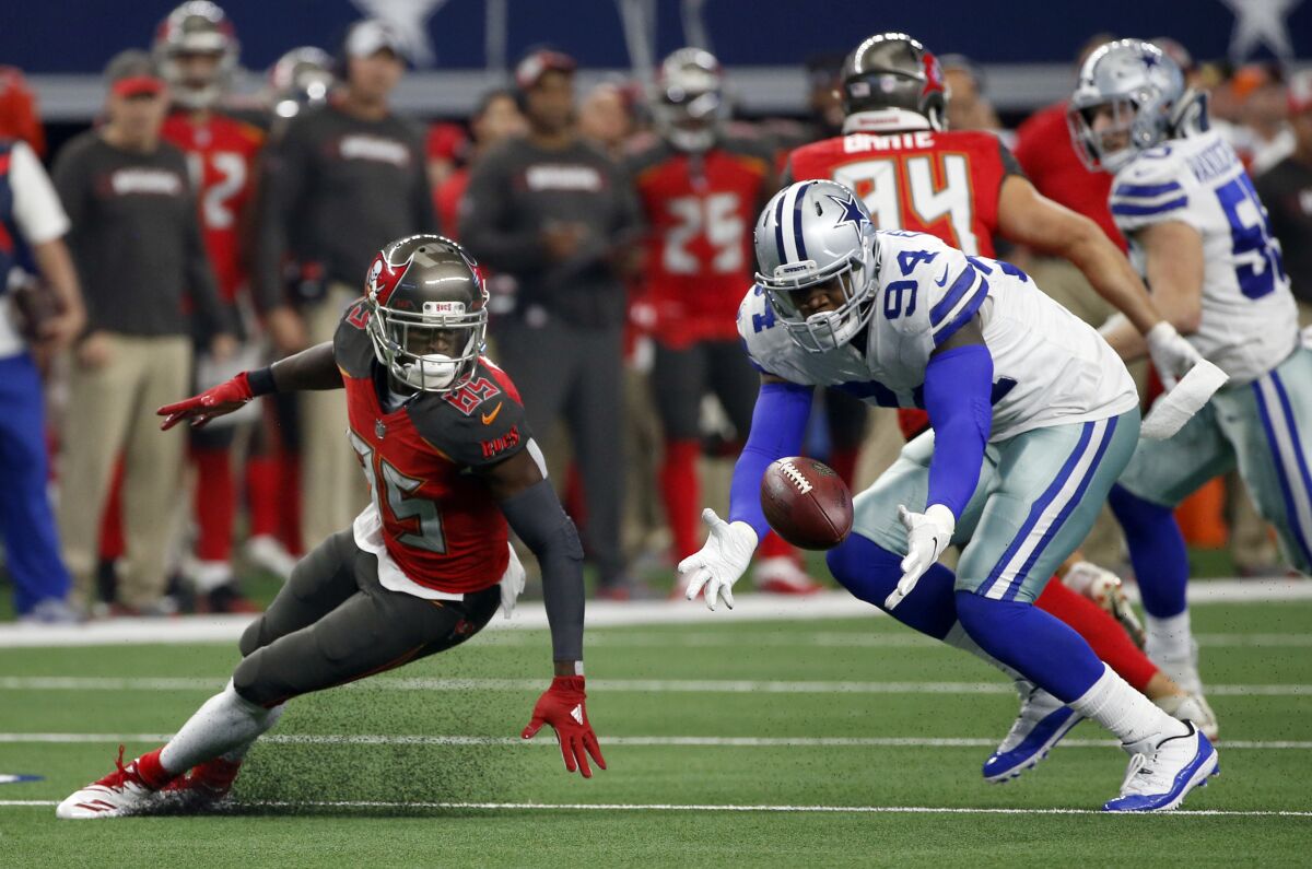 FILE - In this Dec. 23, 2018, file photo, Tampa Bay Buccaneers wide receiver Bobo Wilson (85) watches as Dallas Cowboys defensive end Randy Gregory (94) recovers a fumble in the second half of an NFL football game in Arlington, Texas. Gregory was conditionally reinstated by the NFL on Friday, Sept. 4, 2020, ending his fourth suspension over substance-abuse violations. (AP Photo/Ron Jenkins, File)