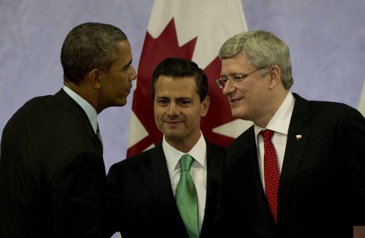 President Obama speaks with Mexican President Enrique Peña Nieto, center, and Canadian Prime Minister Stephen Harper after a news conference in Toluca, Mexico.