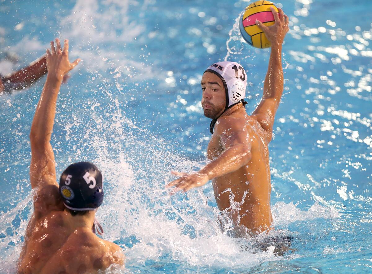 Huntington Beach's Cooper Haddad (13) scores over Newport Harbor's Gage Verdegaal in a Surf League match on Wednesday at Corona del Mar High.