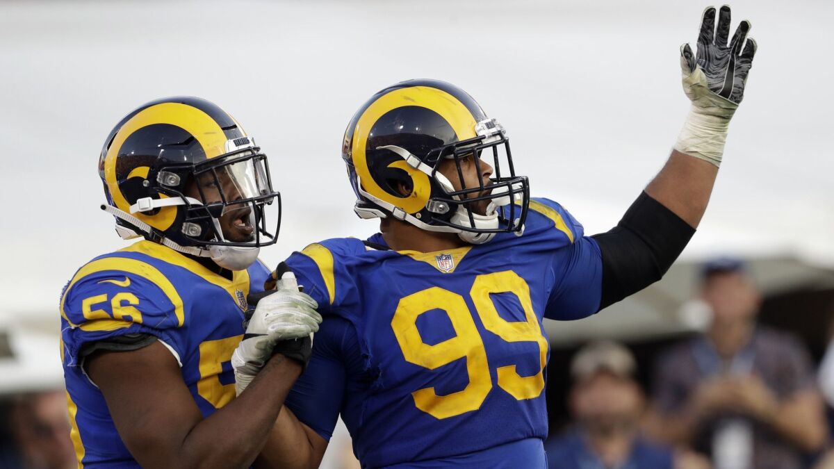 Rams defensive end Aaron Donald (99) celebrates a fumble recovery and touchdown by defensive end Dante Fowler (56) during the second half of last week's game against the Seattle Seahawks.